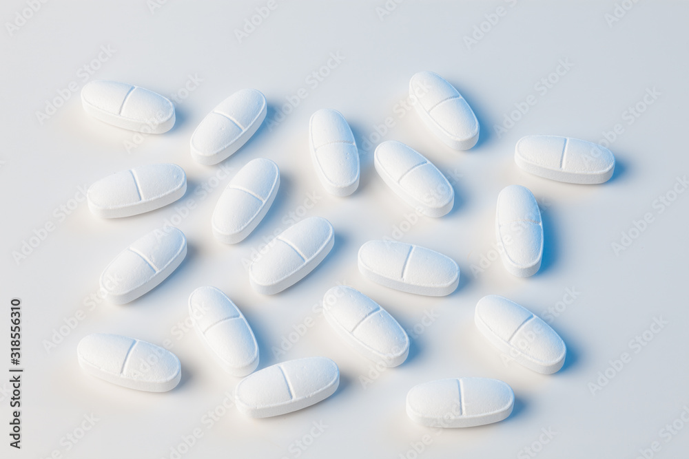 white pills on white background with blue lights white pills on white background with blue lights