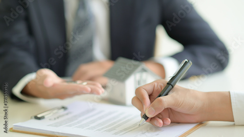 Customer signs a home loan contract with a bank official.