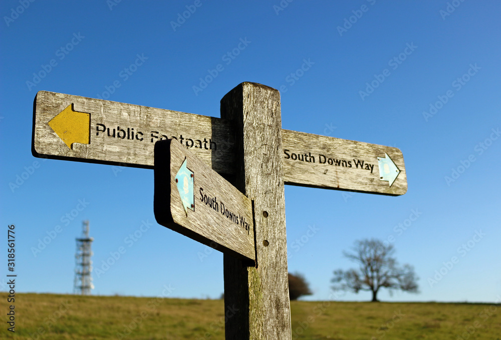 A wooden signpost to the South Downs Way at Butser Hill in Hampshire, England A wooden signpost to the South Downs Way at Butser Hill in Hampshire, England