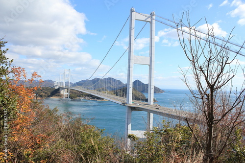 Stylish bridge across on the blue beautiful ocean in Japan © Sammy