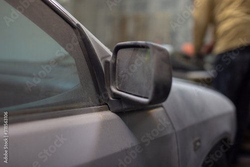 Dirty car in the dust, distant view mirror © Alena Sharuk
