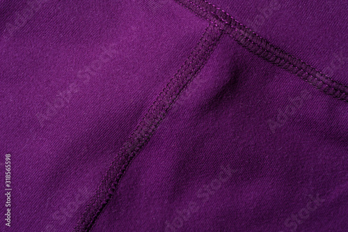 Fragment of crumpled purple polyester wear