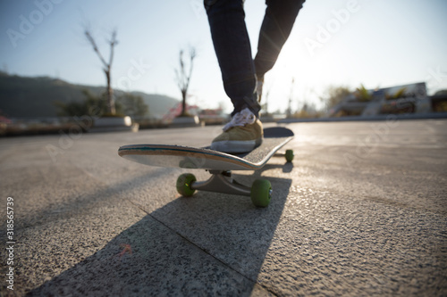 Skateboarder skateboarding at sunrise park