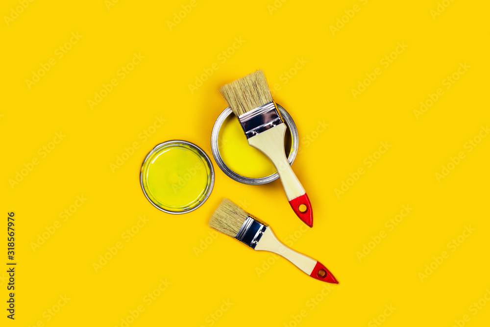 Renovation picture. Yellow background with one paint can and two brushes. Flat lay, top view, copy space. Renovation picture. Yellow background with one paint can and two brushes. Flat lay, top view, copy space.