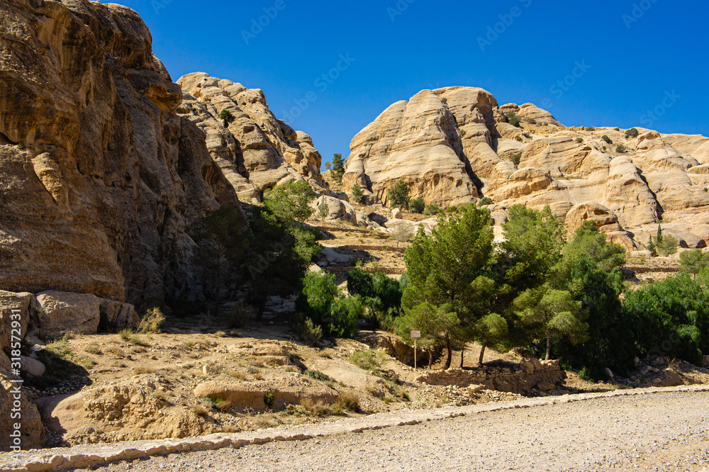 Fototapeta premium Vintage photo from the archive. Road to Sik gorge leading to ancient city of Petra. Between steep cliffs lies pedestrian road to entrance to Sik Gorge.