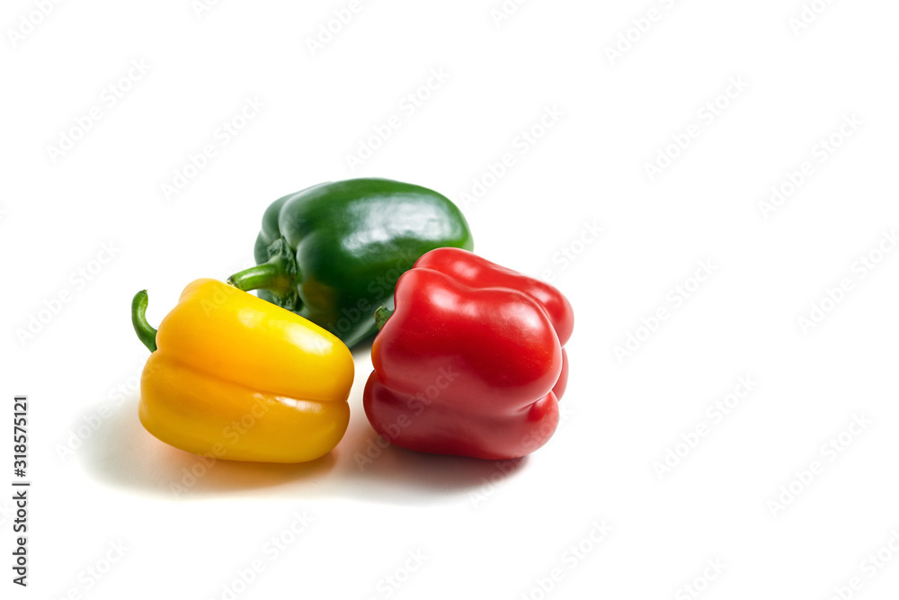 Red, green, and yellow bell peppers isolated on white background. Three sweet peppers in different colors, vegetable ingredient, healthy food Red, green, and yellow bell peppers isolated on white background. Three sweet peppers in different colors, vegetable ingredient, healthy food
