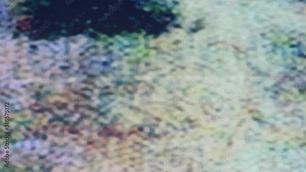 Real glitch, noise on a tv screen. Blurred TV-image is flickering in pixels Real glitch, noise on a tv screen. Blurred TV-image is flickering in pixels