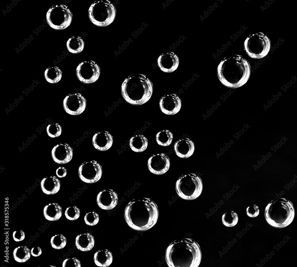 Air balls in water on a black background