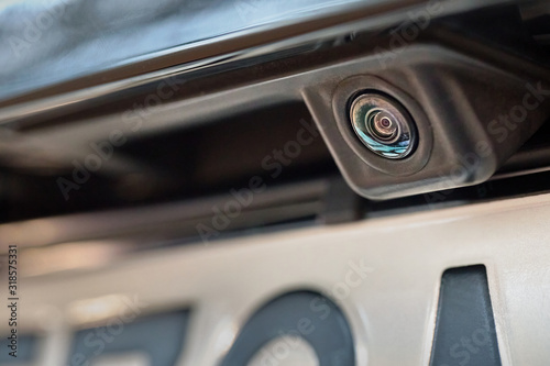 Luxury car rear view camera close up for parking assistance. Concept of safety car driving while parking process. Assist device equipment in modern cars © R_Yosha