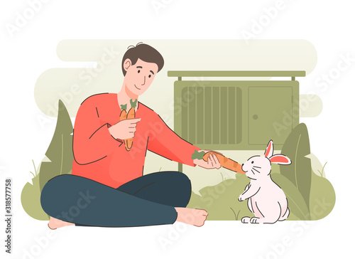 Man feeding rabbit with carrot. People and their pet concept
