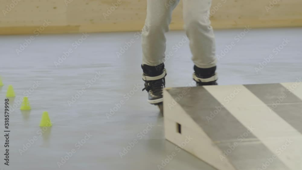 Sequence of shots of Caucasian bearded man jumping from springboard and then slaloming in indoor skate park Sequence of shots of Caucasian bearded man jumping from springboard and then slaloming in indoor skate park