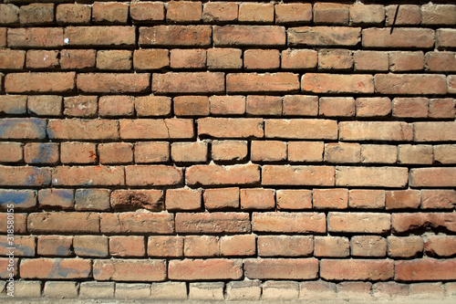 Part of the brick wall in the old town. Different bricks, whole and slightly broken. Part 2