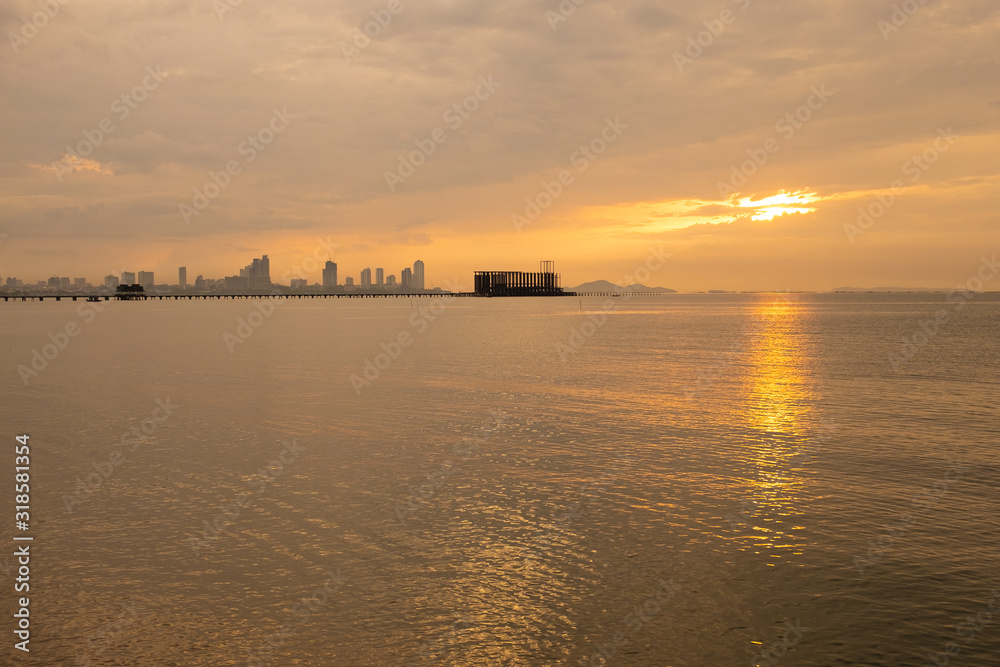 Tropical beach at beautiful sunset. city background