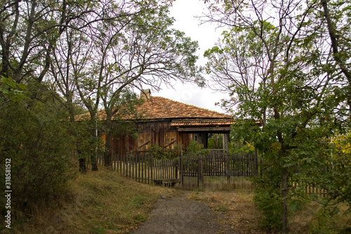 Fényképezés Abandoned wooden georgian house with a nice fence