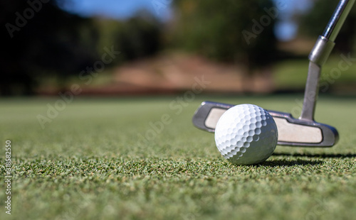 Close Up of Golf club and ball in grass.