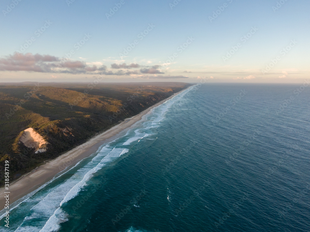 High angle aerial drone view of famous Seventy Five Mile Beach near Dundubara Creek on Fraser Island, Queensland, Australia, shortly before sunset. High angle aerial drone view of famous Seventy Five Mile Beach near Dundubara Creek on Fraser Island, Queensland, Australia, shortly before sunset.