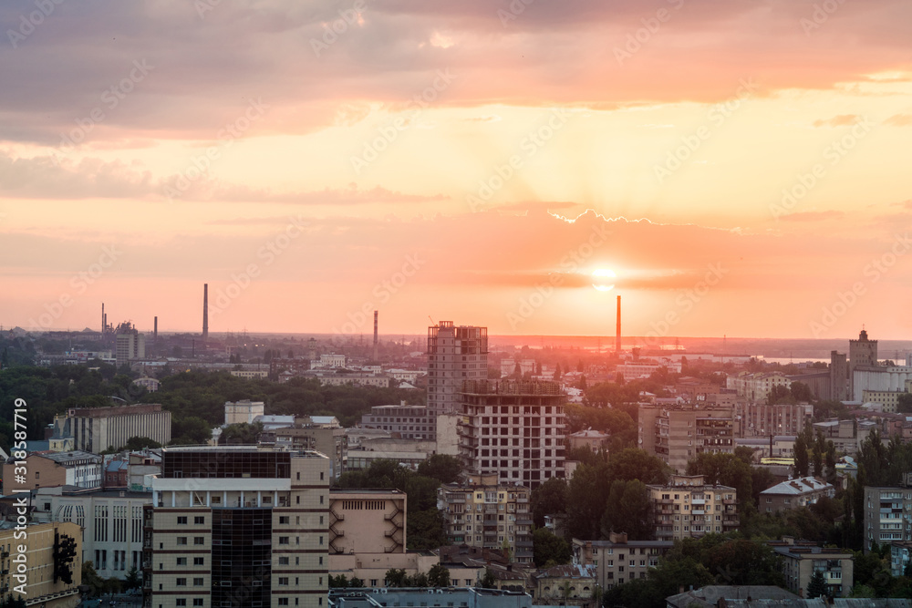 Urban landscape industrial city from a height. View of the sunset from the roof of a tall building.