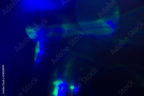 Blurred lens flare. Defocused colorful lights. Shiny glowing spots, abstract background and texture