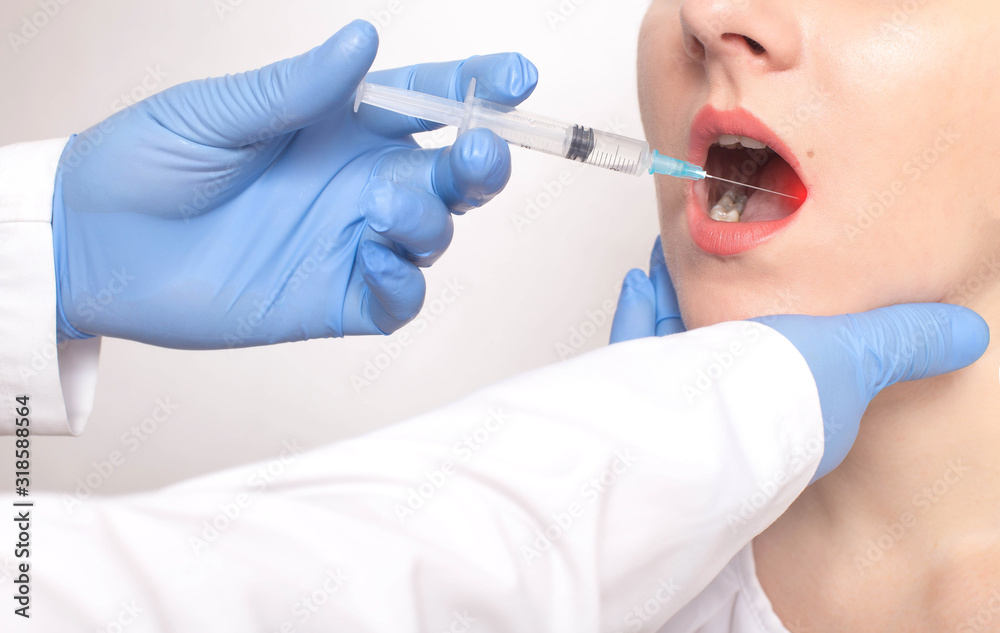 The doctor does a biopsy of the tongue with a syringe in the patient s tongue. Concept check benign and malignant tumors, cancer of the tongue, sickness The doctor does a biopsy of the tongue with a syringe in the patient s tongue. Concept check benign and malignant tumors, cancer of the tongue, sickness