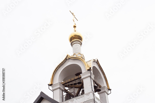 Beautiful church with a golden dome and bells against the sky, architectural, copy space, historic photo