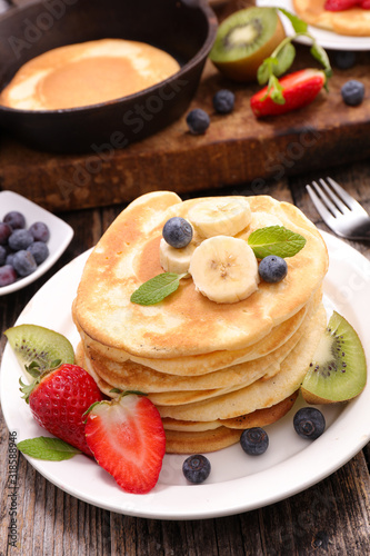 pancakes with banana, strawberry and blueberry