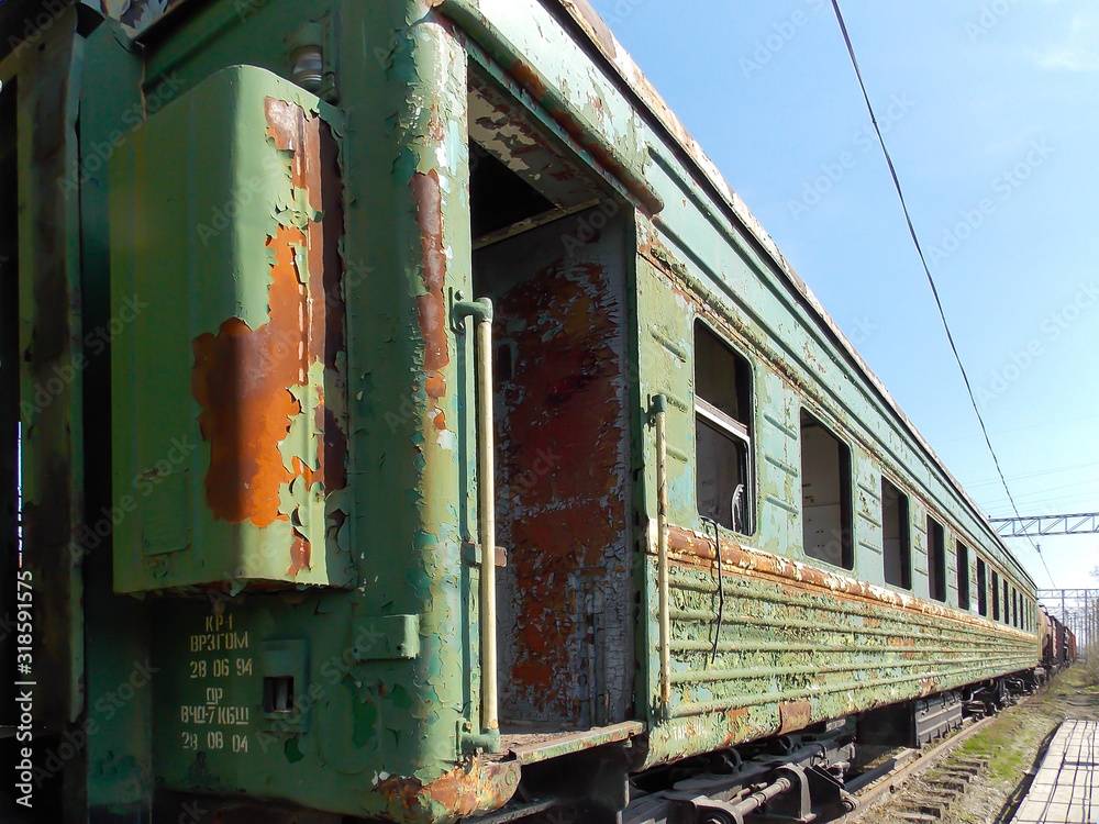 Old green passenger train car without glasses. Outside. Old green passenger train car without glasses. Outside.