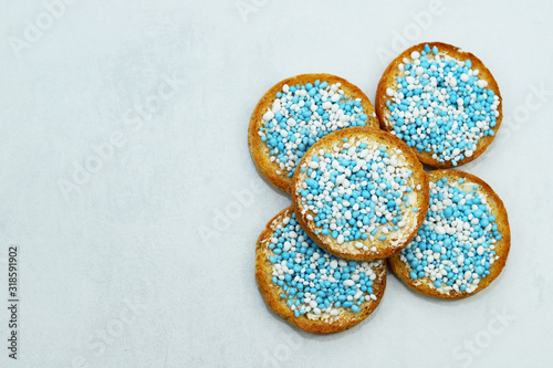 Rusk with blue and white anise seeds called beschuit met muisjes. Traditional Dutch tread to celebrate the birth of baby boy.