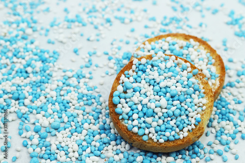 Rusk with blue and white anise seeds called beschuit met muisjes. Traditional Dutch tread to celebrate the birth of baby boy.