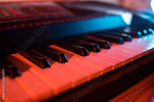Synthesizer keys in neon light. Piano buttons in the dark