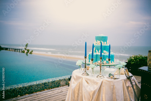 Blue wedding cake on wedding ceremony at seaside 