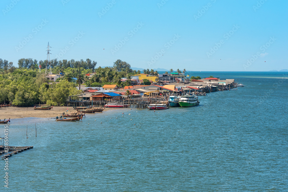 The village Ban Saladan on Ko Lanta, where all ferries and boats arrive, situated at the estuary of a watercourse into the Andaman sea. The waterway leads to the mangroves woods inland site