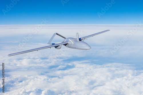 Unmanned aerial vehicles spy in the sky flying over dense clouds over the territory of patrol.