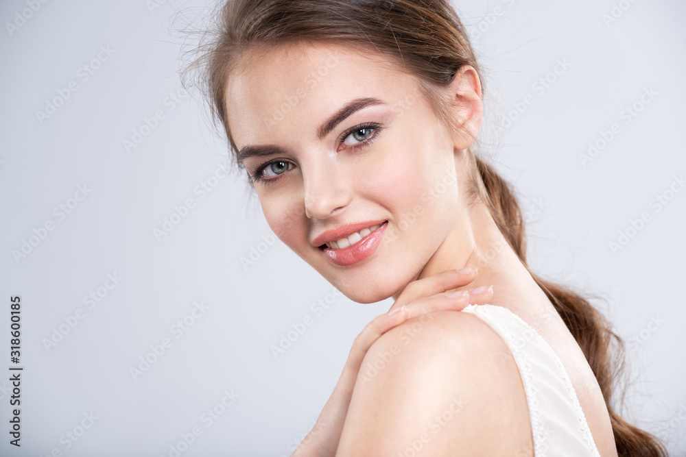 Portrait of a smiling young woman with a brown hair. Portrait of a smiling young woman with a brown hair.