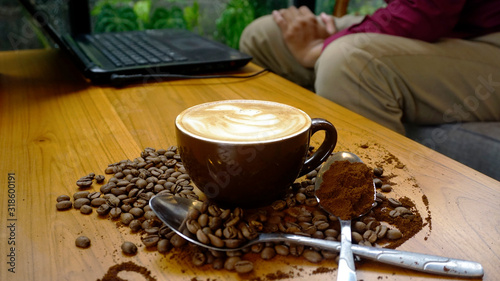 Coffee Latte with coffee beans scattered on the table