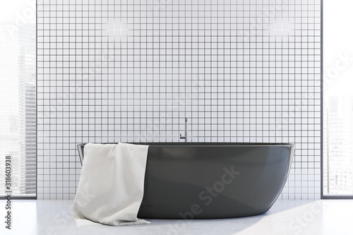 White tile bathroom interior with tub