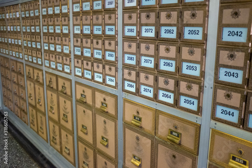 Rows of vintage post boxes of assorted sizes