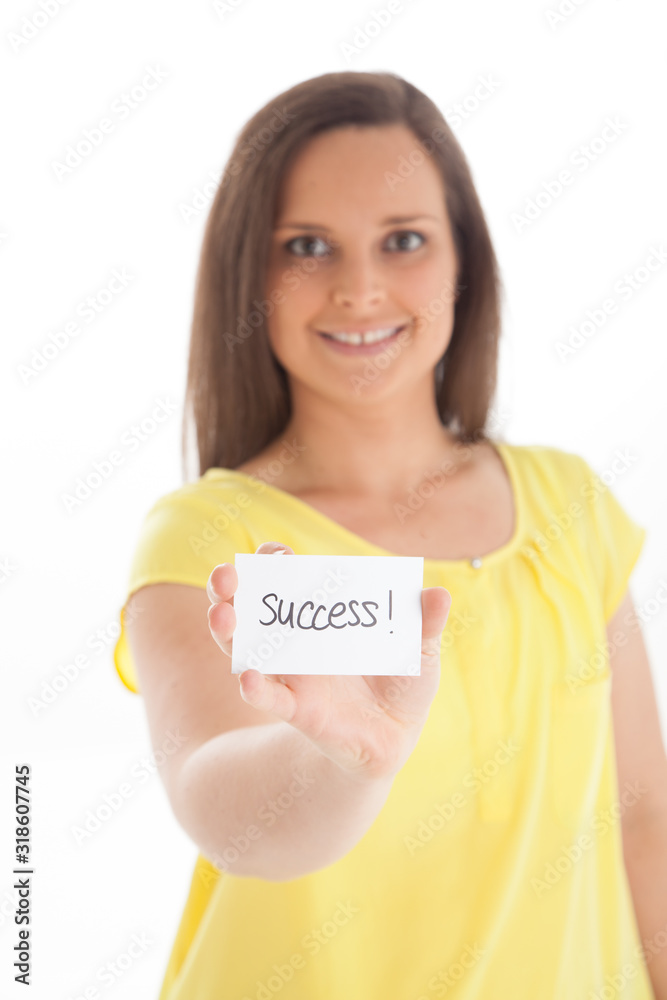 Smiling female holding success message in her hands on white background Smiling female holding success message in her hands on white background