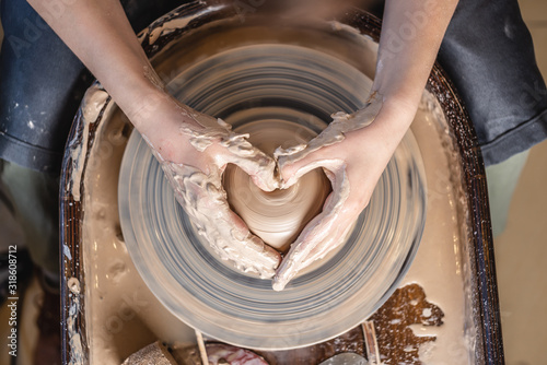 Bilde på lerret Potter working with clay on a Potter's wheel