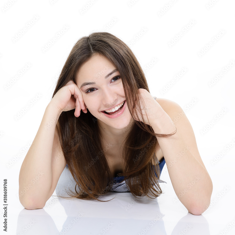Portrait of attractive teen girl looking at camera over white. Studio portrait of beautiful cheerful young woman Portrait of attractive teen girl looking at camera over white. Studio portrait of beautiful cheerful young woman