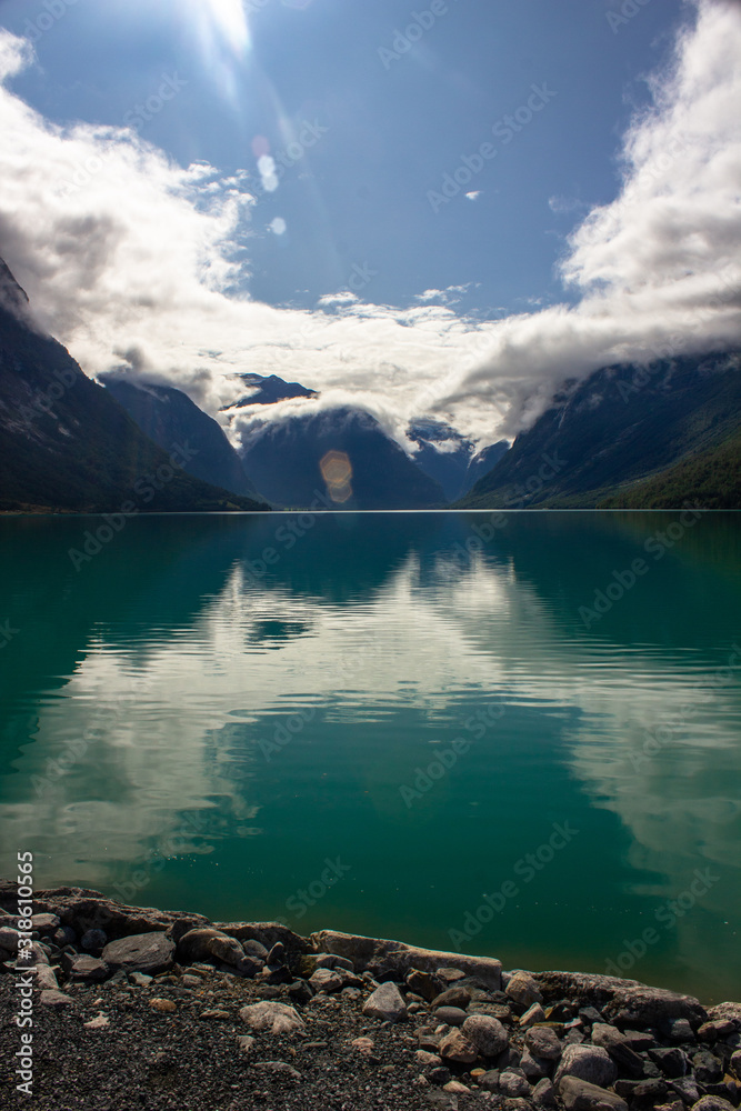 Beautiful view of the turquoise lake and mountains from the shore Beautiful view of the turquoise lake and mountains from the shore