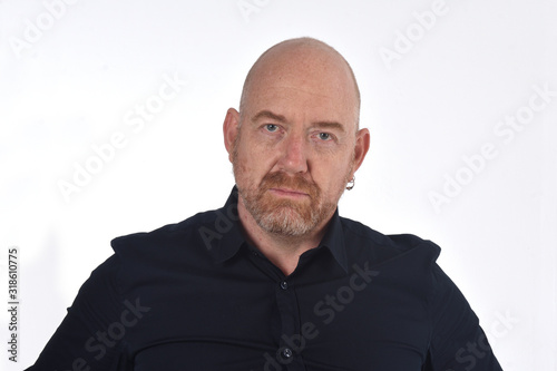 portrait of bald man on white, serious
