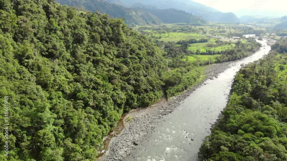 Aerial tilt down to Rio Quijos, a tributary of the Amazon in Ecuador, view upstream looking towards the Andes Aerial tilt down to Rio Quijos, a tributary of the Amazon in Ecuador, view upstream looking towards the Andes