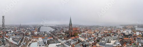 Panorama aerial lake view of Schwerin Cathedral by lake amist heavy fog and haze in the morning