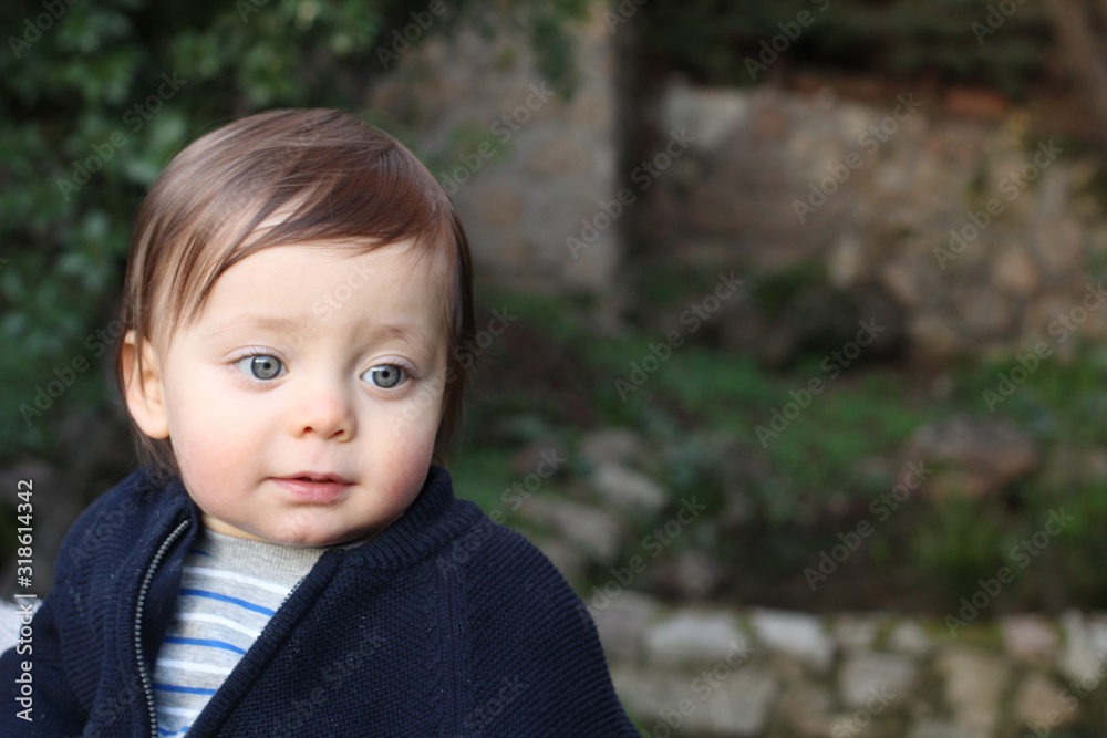 One year old baby smiling outdoors One year old baby smiling outdoors