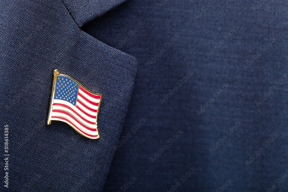 Element of male suit with USA flag pin on chest - studio shot - obrazy, fototapety, plakaty 