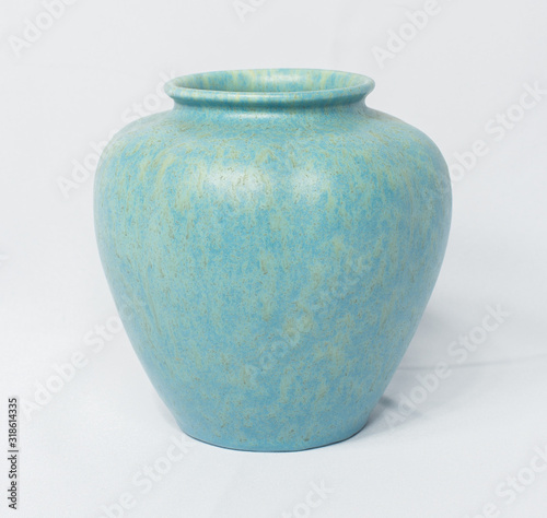 A vintage antique ceramic fragile pottery royal lancastrian 1916 blue and aqua vase isolated on a white background. old pottery pots from the past, found in junk shops and thrift stores. photo