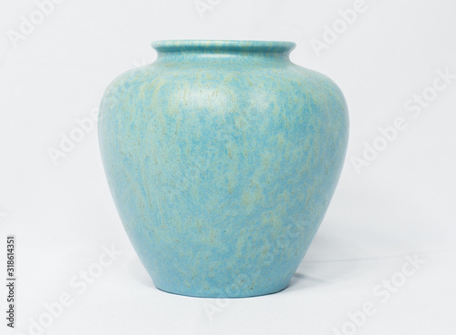 A vintage antique ceramic fragile pottery royal lancastrian 1916 blue and aqua vase isolated on a white background. old pottery pots from the past, found in junk shops and thrift stores.