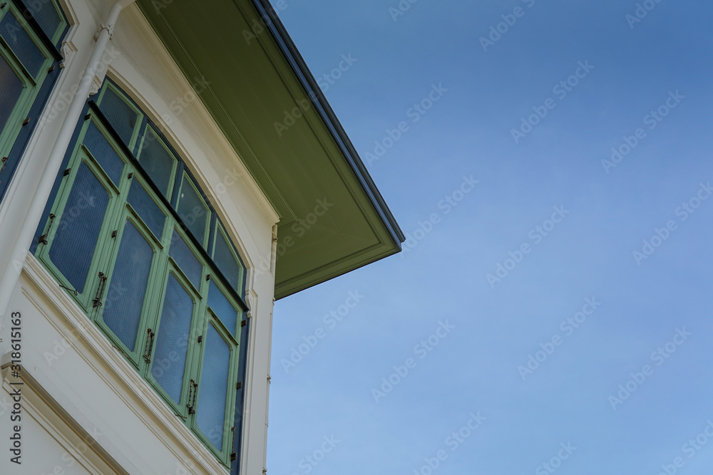 Traditional colonial style building against blue sky
