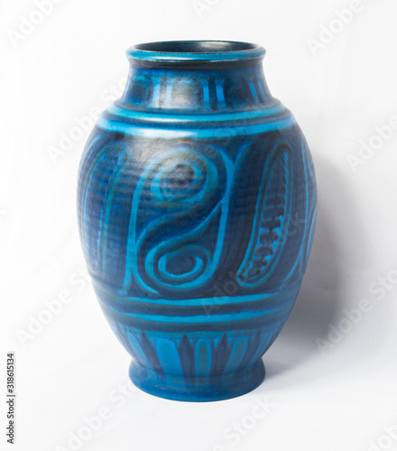 A vintage antique ceramic fragile pottery royal blue vase isolated on a white background. old pottery pots and objects from the past, found in junk shops and thrift stores.