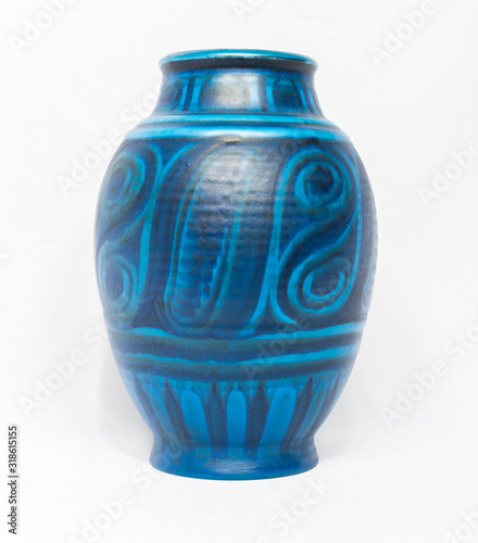A vintage antique ceramic fragile pottery royal blue vase isolated on a white background. old pottery pots and objects from the past, found in junk shops and thrift stores.